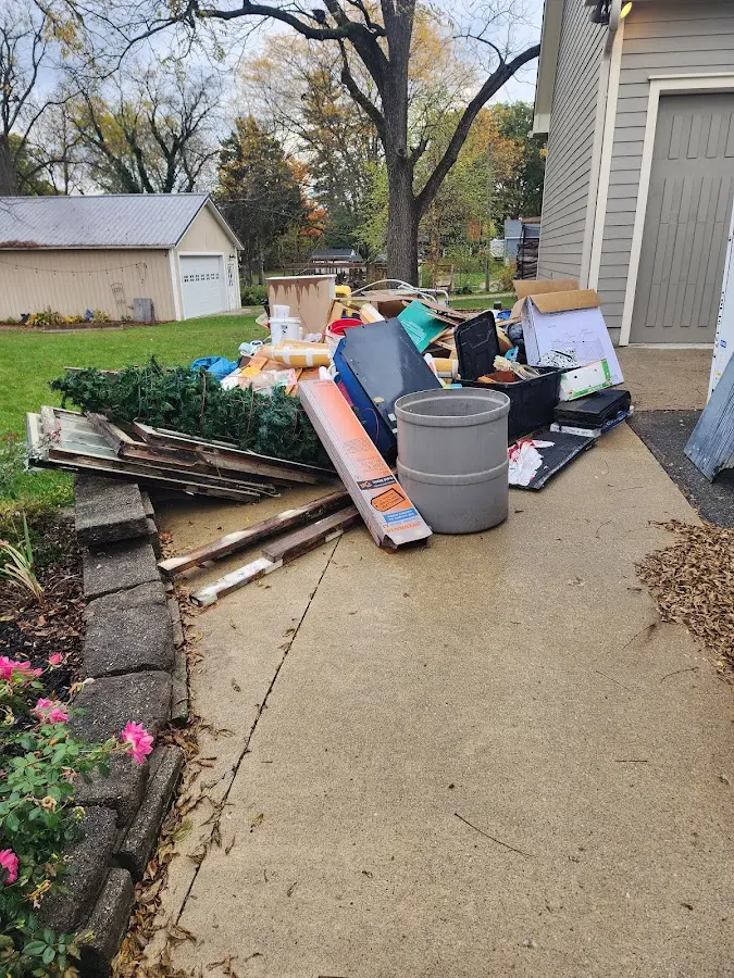 Dumpster being loaded with debris for Estate Cleanout Dumpster Rental in Ste. Genevieve